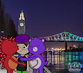 Loving each other in front of the illuminated Jacques-Cartier Bridge